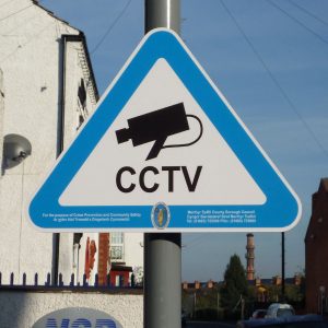 Triangle CCTV sign with blue border mounted to lamppost