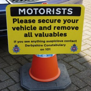 temporary cone mounted sign advising motorists to secure your vehicle & remove all valuables