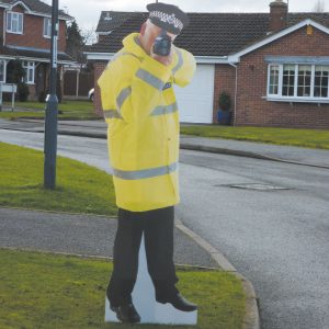 cardboard cut out police man holding speed gun