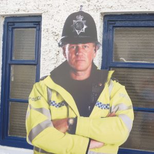 close up of a cardboard cut out policeman