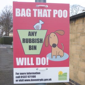 correx sign with a bag that poo message for dog owners