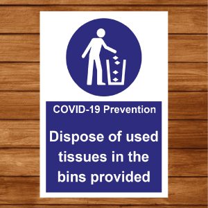 information sign advising people to dispose of used tissues in nearby bin