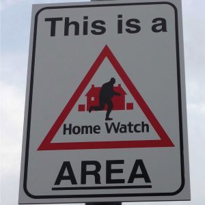 this is a home watch area sign mounted to a lamppost