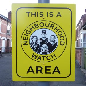 yellow post mounted neighbourhood watch sign