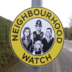 circle neighbourhood watch sign mounted to a lamppost