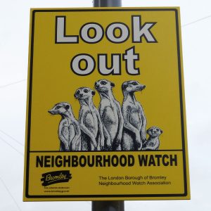 neighbourhood watch sign with meercats in the design mounted to a lamppost