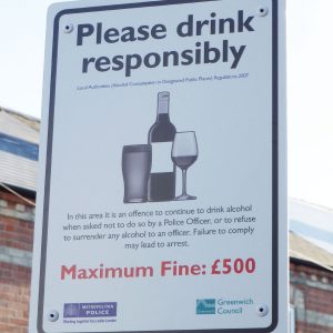 white post mounted please drink responsibly sign for greenwich council