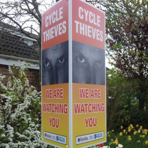 tri-ad sign with signs with eyes design used to deter bike thieves