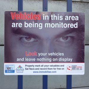 landscape sign with signs with eyes design used to deter car thieves