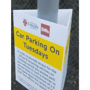 tri-ad sign attached to lamppost giving information of parking on a tuesday