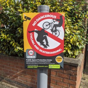 no dangerous cycling or skateboarding in this area sign mounted to a post