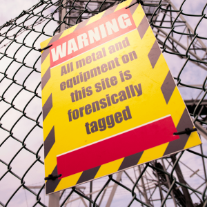Yellow & black warning sign mounted to wire fence