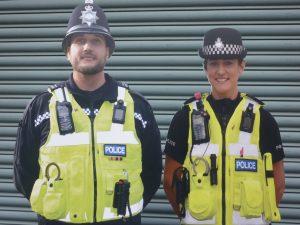 pair of cardboard cut out police workers