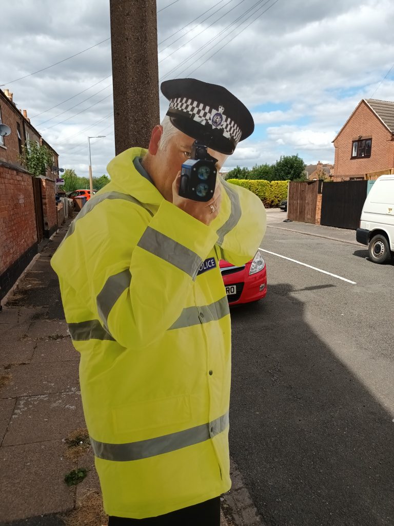 cut out policeman with speed gun on a housing estate